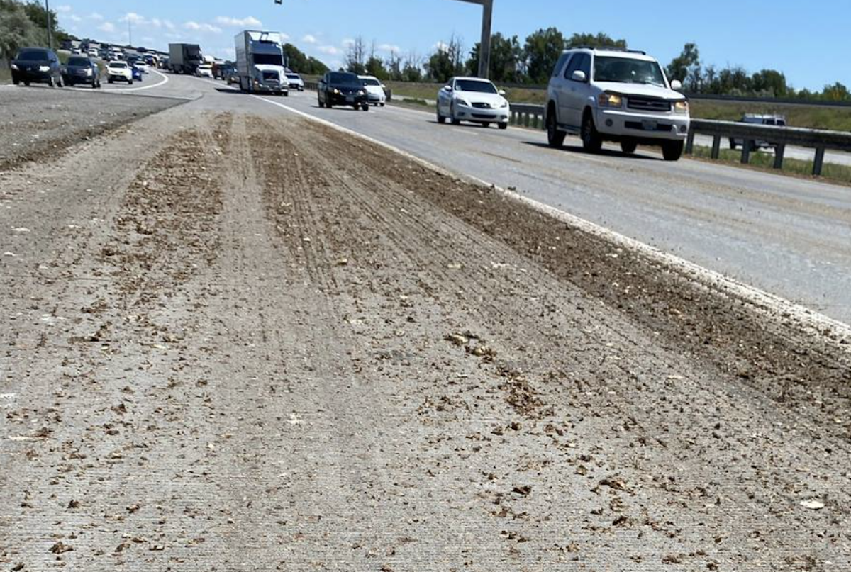 Motorcycles slide on potato sludge left on roadway