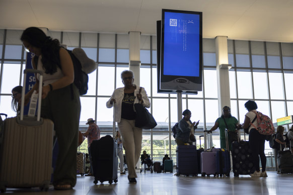 Outage everywhere: Screens show a blue error message at a departure floor of LaGuardia Airport in New York.