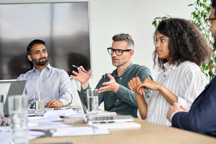 people sitting at table during business meeting