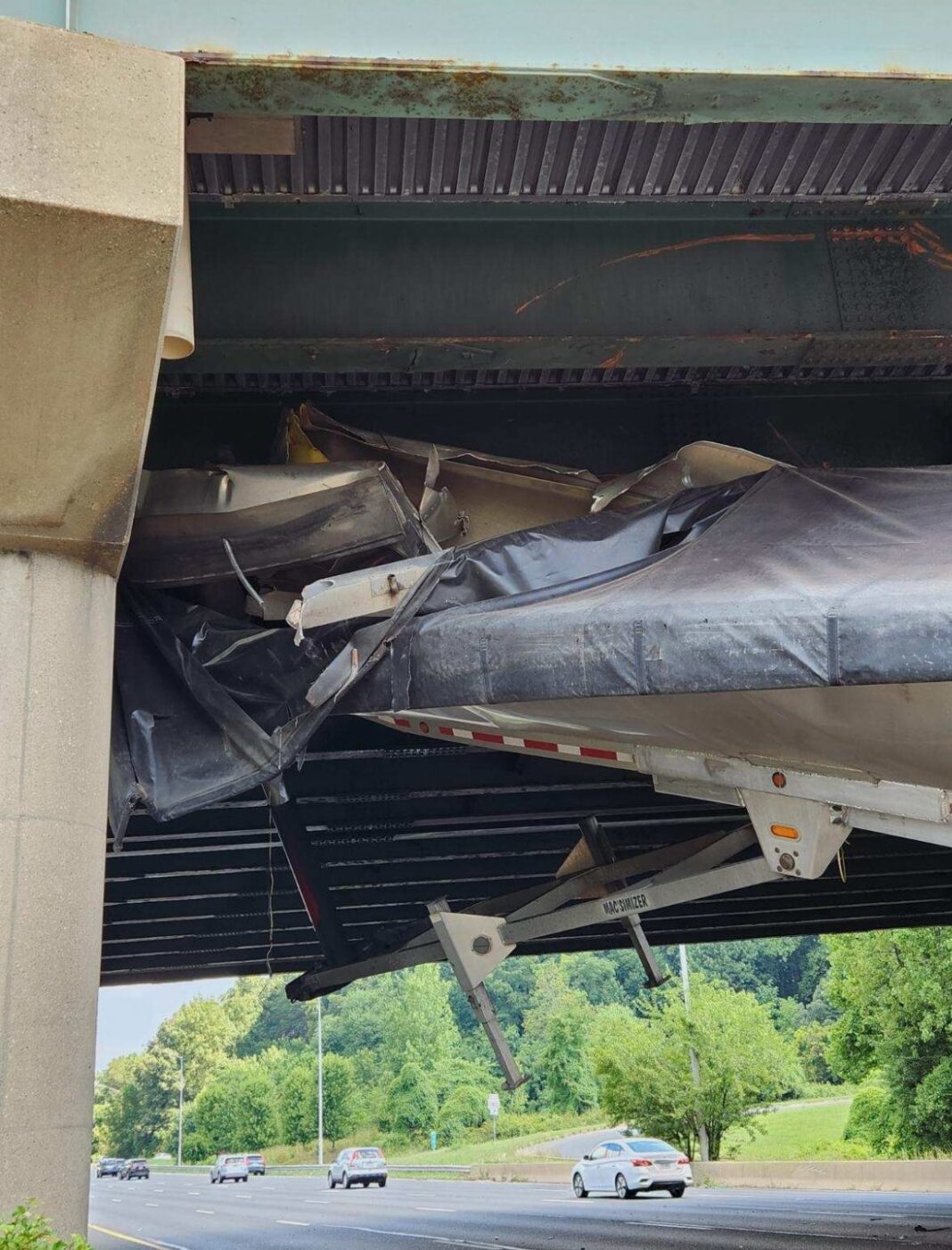 One hospitalized after commercial vehicle strikes bridge, car strikes detached trailer