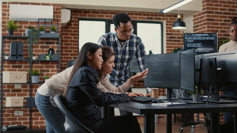 An IT team hard at work, used to illustrate a story about the cybersecurity communications gap.