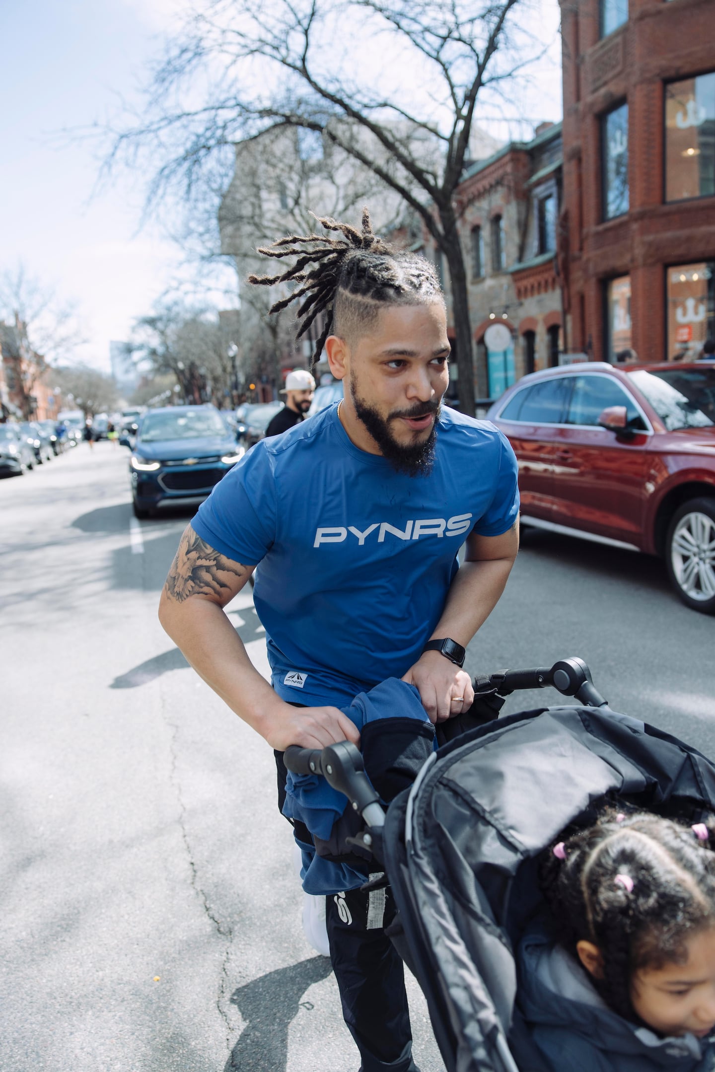 Bruce Baptista wore a running shirt from his brother's Boston-based clothing company, PYNRS, as part of a Pioneers Run Crew event on April 14.