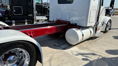 Red frame and white cab of T&M Services' 2023 Peterbilt 567