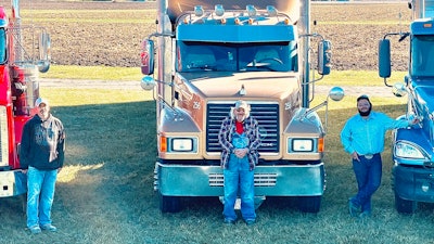 Foreman family with their trucks