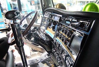 View of the dash and steering wheel inside the truck, likewise the skull-topped shifter -- christened 'Leroy' after McCormick's moniker for a fictional codriver he told tall tales of in his chicken-hauling days long ago.