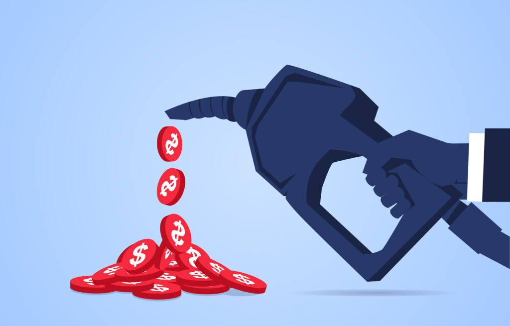 Dollar gold coins flowing out from a hand holding a fuel gun